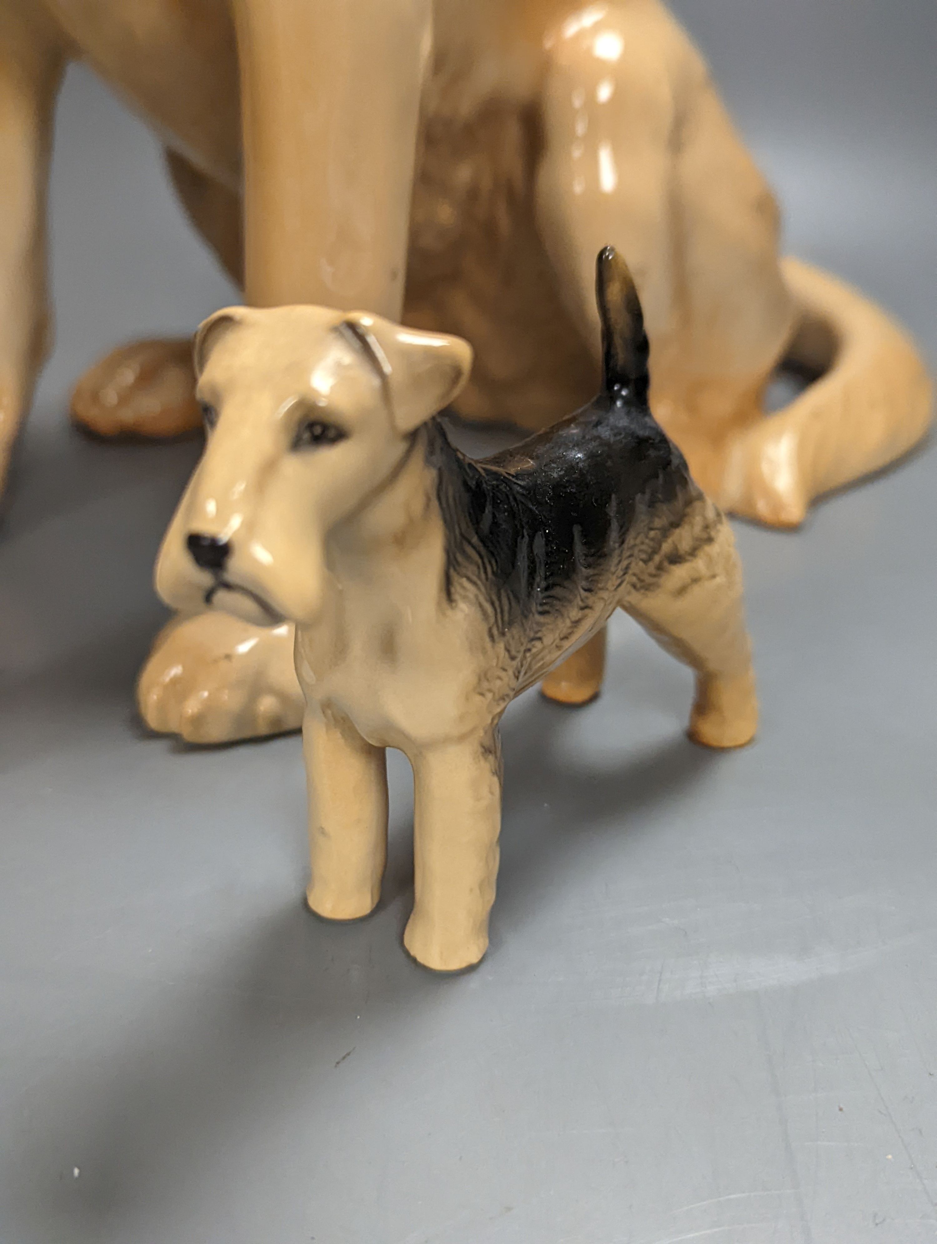 A Royal Doulton figure of a seated Labrador (No. 2314), height 34cm, a small Beswick Airedale Terrier and another (3)